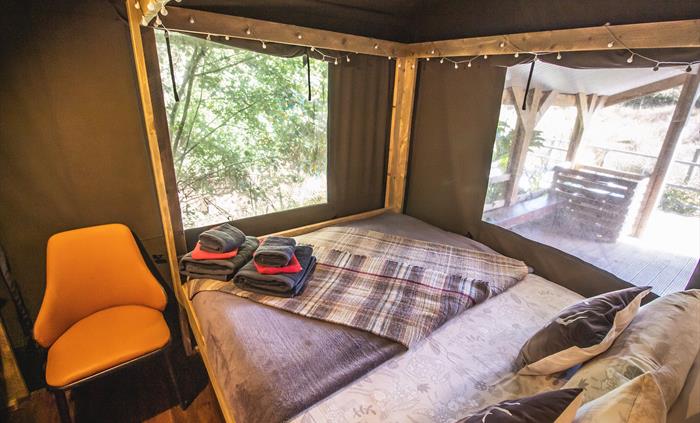Comfortable four poster bed in a private bedroom
